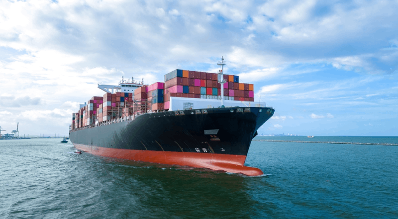 Aerial Side View Of Cargo Ship Carrying Containers